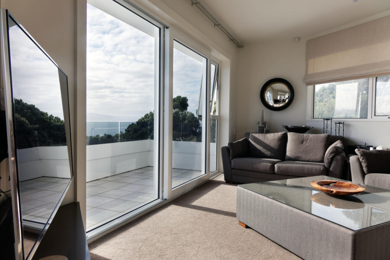 A sliding patio door with a view out to sea
