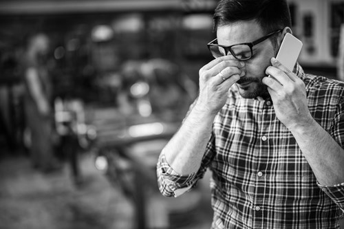 A stressed man in a factory