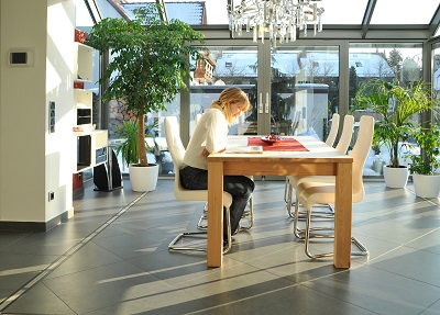 A woman sitting in front of a conservatory