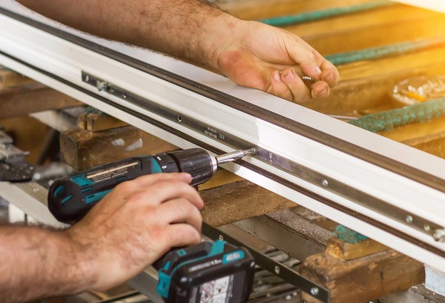 Drilling a screw into a windowframe