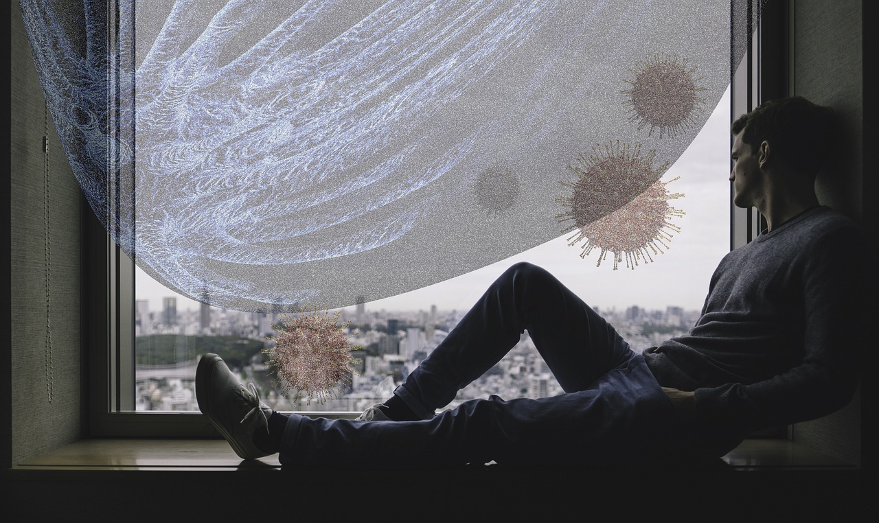 A man sitting by a window looking fed up