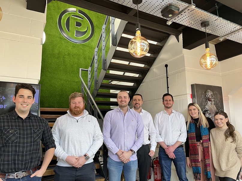 A group of people posing for a photo in an office