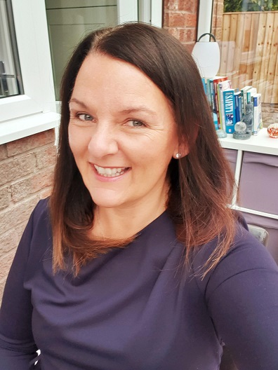 A woman with brown hair smiling