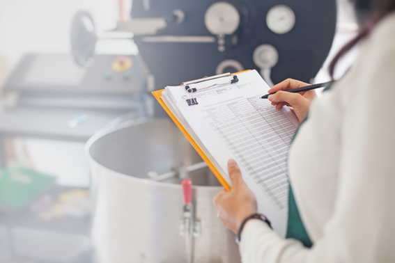 A woman in a factory with a clipboard